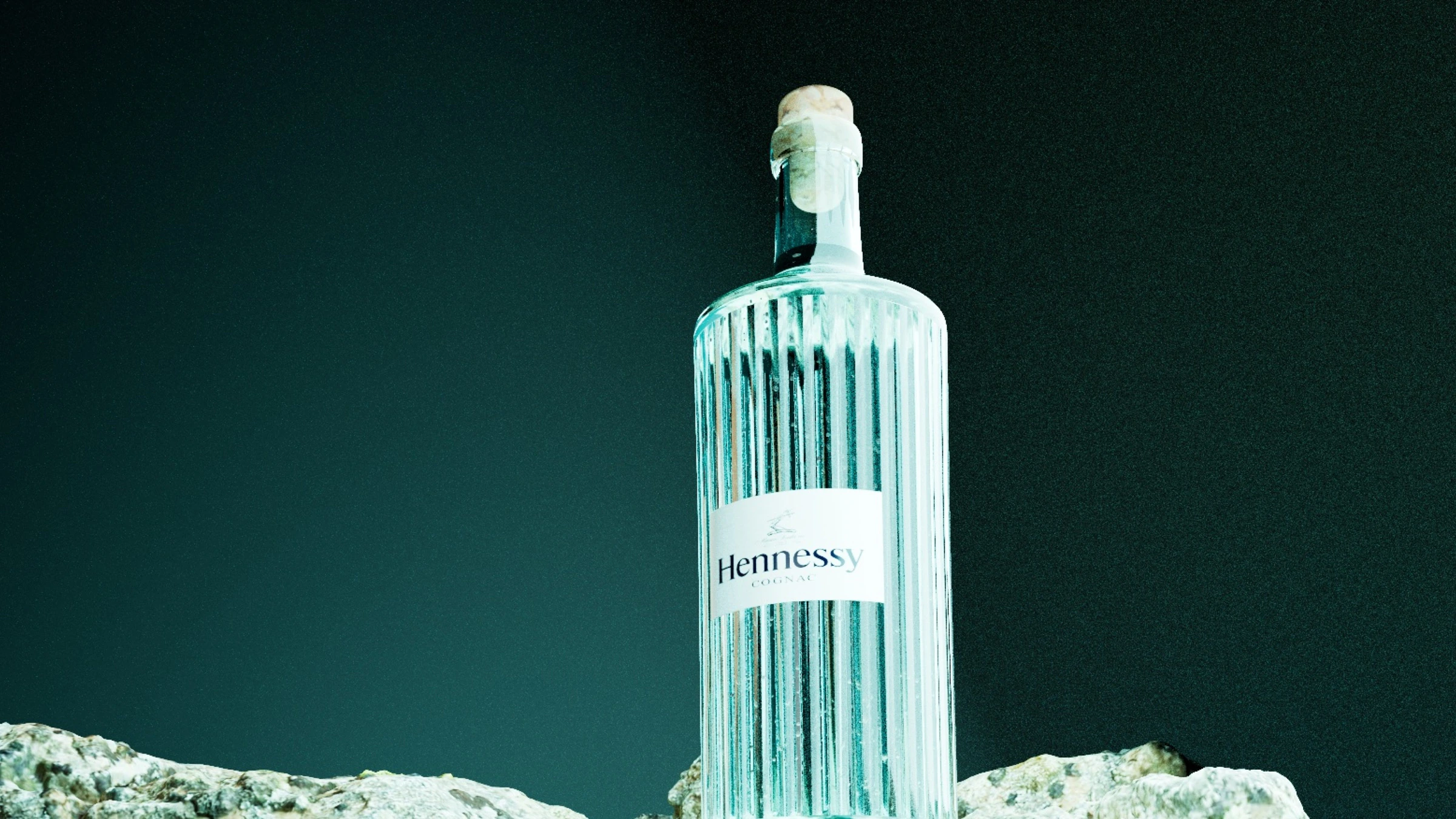 Hennessy close-up 3D bottle render with glass texture and dark green background by Kalypt Studio